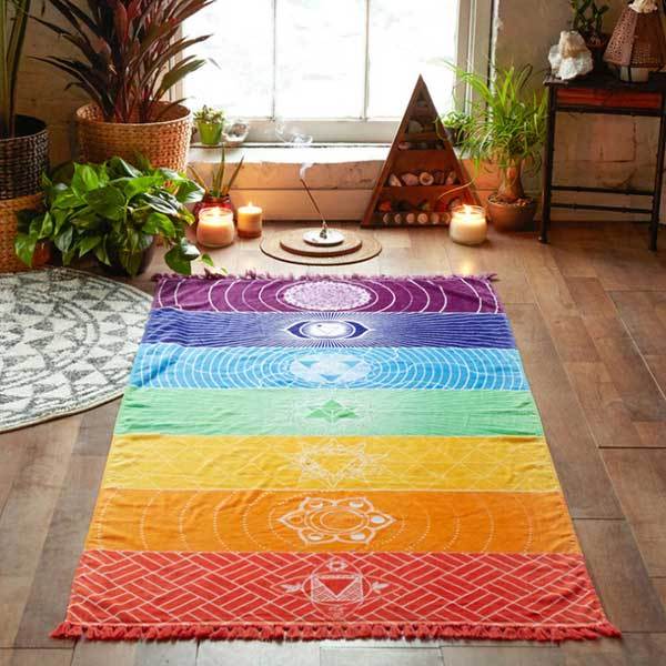 7 Chakra Yoga Mat laid flat on a wooden floor