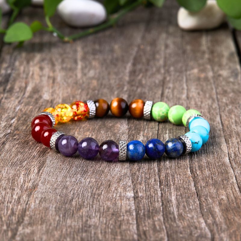 7 Chakra stone healing bracelet on wooden table